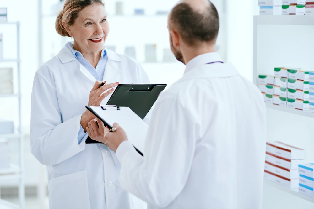 pharmacist owner talking to partner about pharmacy growth strategies