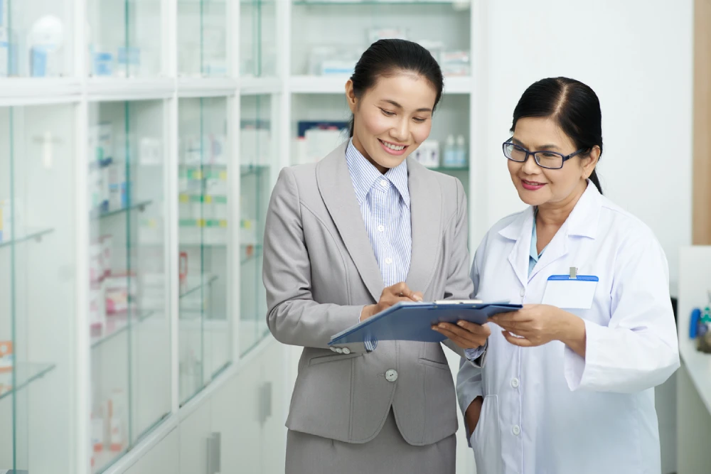 pharmacy business advisor showing a pharmacist a list of pharmacy opportunities