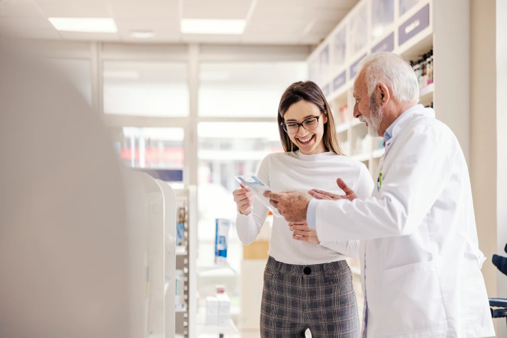 a pharmacist and pharmacy advisor looking at store signage