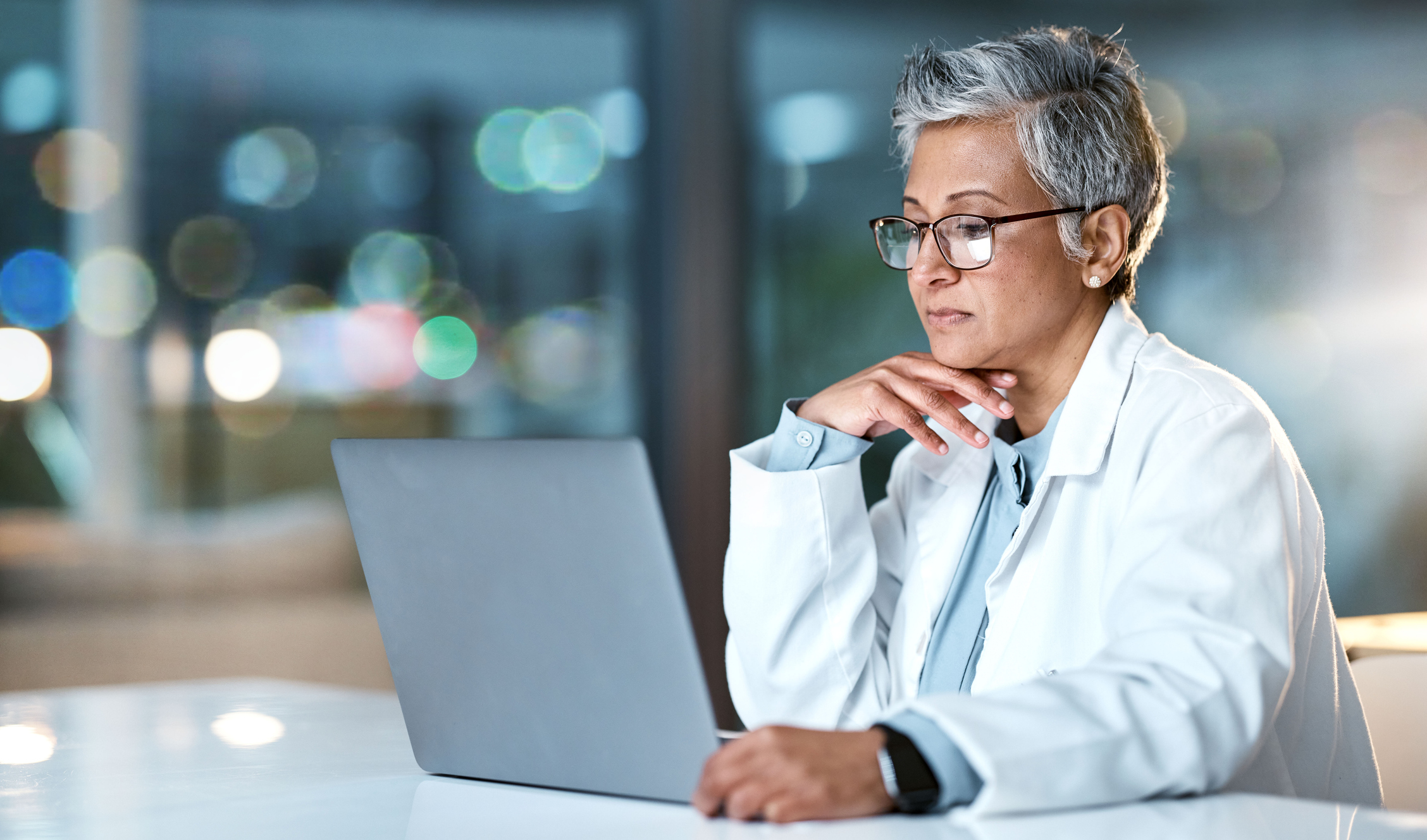 Doctor working on a laptop.
