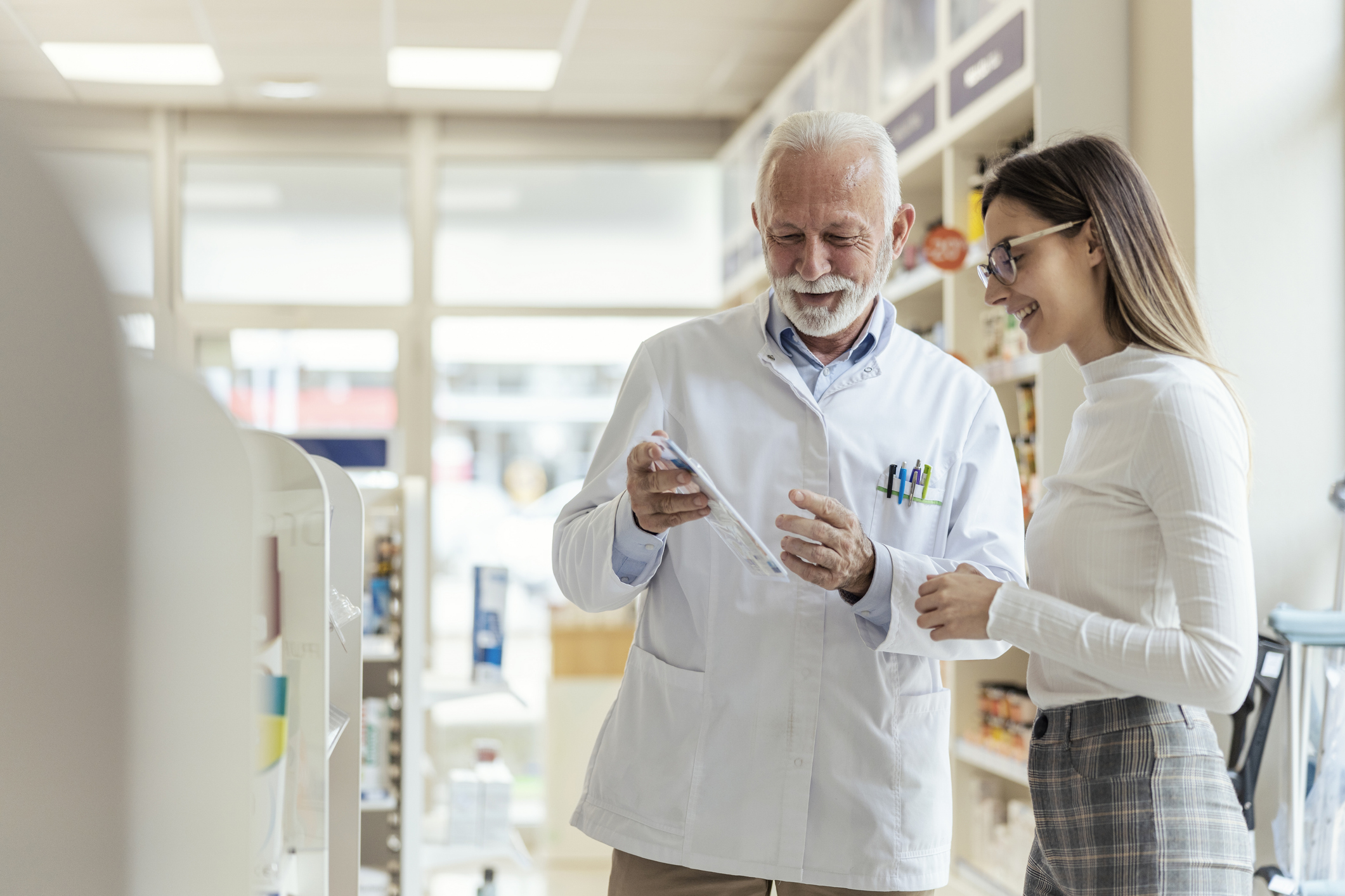 Pharmacist consulting with a customer.
